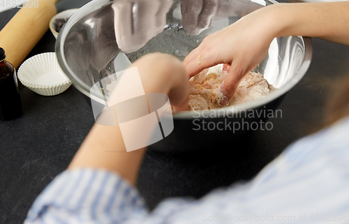 Image of close up of hands kneading dough at bakery