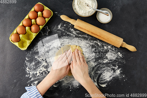 Image of hands making shortcrust pastry dough on table