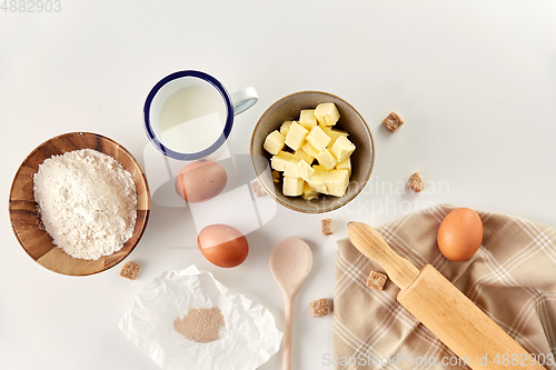 Image of rolling pin, butter, eggs, flour, milk and sugar
