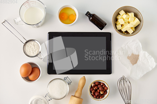 Image of tablet computer and cooking ingredients on table