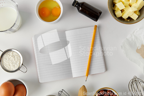 Image of recipe book and cooking ingredients on table