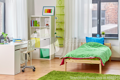 Image of kid's room interior with bed, table and bookcase