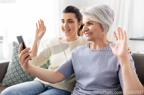 Image of daughter and old mother having video call on phone