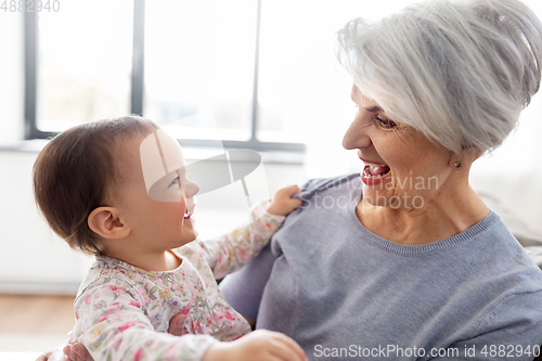 Image of happy grandmother with baby granddaughter at home