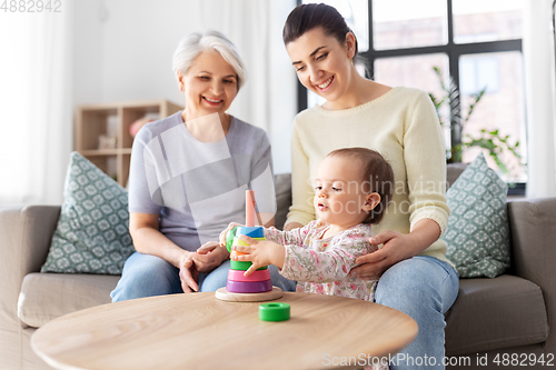 Image of mother, baby daughter and granny playing at home