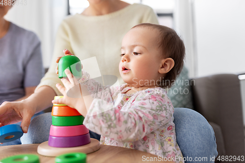 Image of mother, baby daughter and granny playing at home