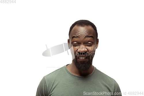 Image of Young african-american man with funny, unusual popular emotions and gestures isolated on white studio background