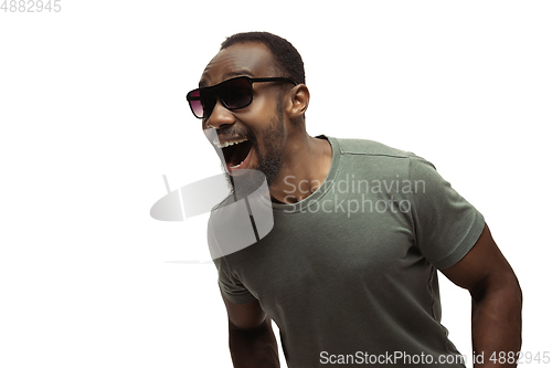 Image of Young african-american man with funny, unusual popular emotions and gestures isolated on white studio background