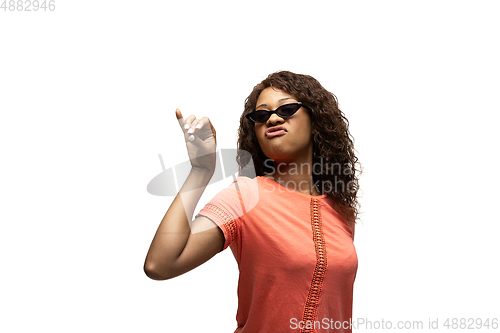 Image of Young african-american woman with funny, unusual popular emotions and gestures isolated on white studio background