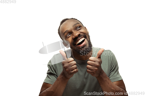 Image of Young african-american man with funny, unusual popular emotions and gestures isolated on white studio background