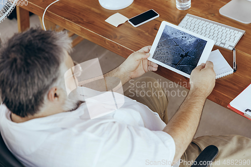 Image of Businessman, manager in office with computer and fan cooling off, feeling hot, flushed