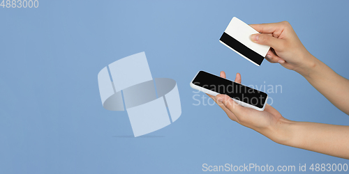 Image of Female hands with phone, credit card and tablet with copyspace on blank screen