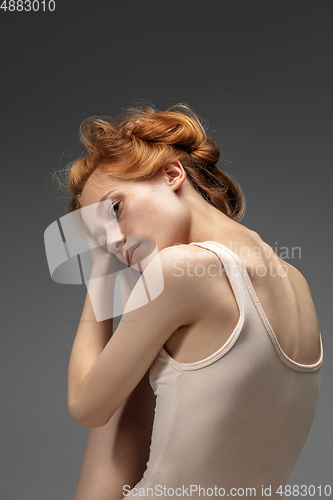 Image of Portrait of beautiful redhead woman isolated on grey studio background. Concept of beauty, skin care, fashion and style