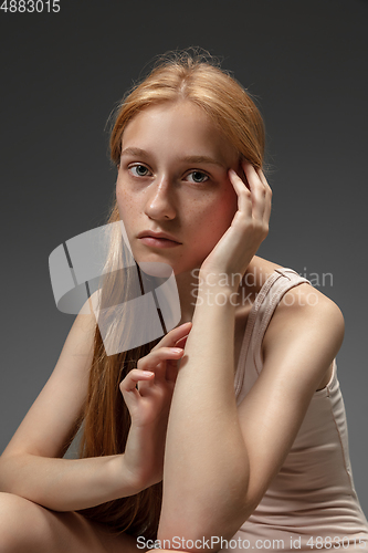 Image of Portrait of beautiful redhead woman isolated on grey studio background. Concept of beauty, skin care, fashion and style