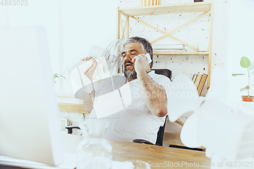 Image of Businessman, manager in office with computer and fan cooling off, feeling hot, flushed