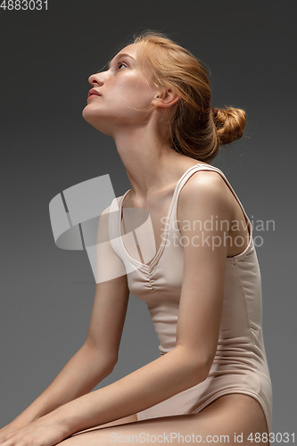 Image of Portrait of beautiful redhead woman isolated on grey studio background. Concept of beauty, skin care, fashion and style