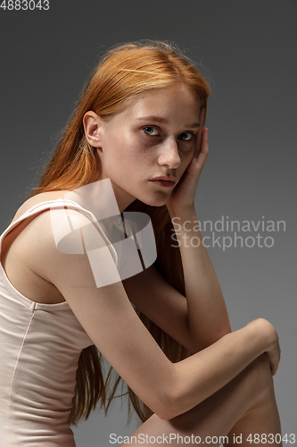 Image of Portrait of beautiful redhead woman isolated on grey studio background. Concept of beauty, skin care, fashion and style