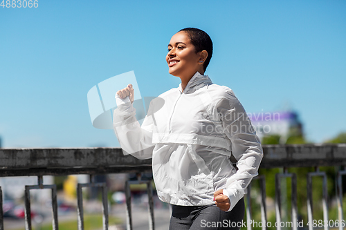 Image of african american woman running outdoors