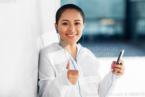 Image of african american woman with earphones and phone