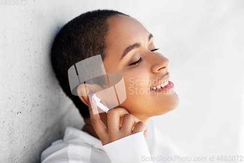 Image of happy african american woman with earphones