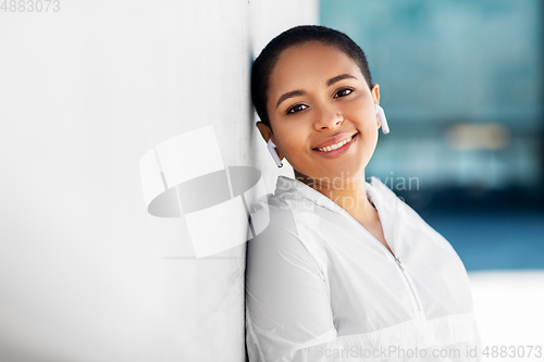 Image of happy african american woman with earphones