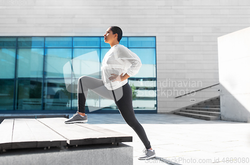 Image of african american woman doing sports outdoors