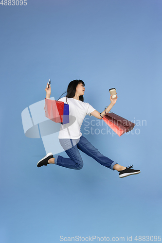 Image of Portrait of young asian woman isolated on blue studio background