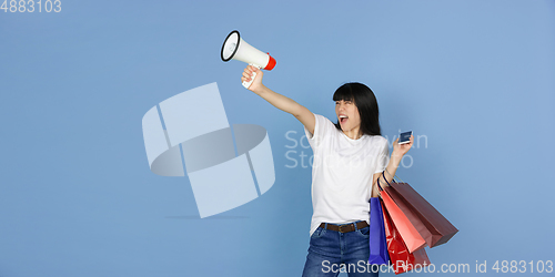 Image of Portrait of young asian woman isolated on blue studio background