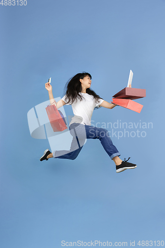 Image of Portrait of young asian woman isolated on blue studio background
