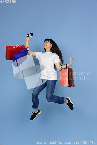 Image of Portrait of young asian woman isolated on blue studio background
