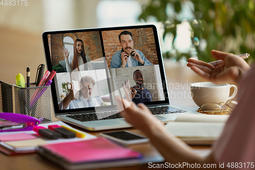 Image of Remote meeting. Woman working from home during coronavirus or COVID-19 quarantine, remote office concept.