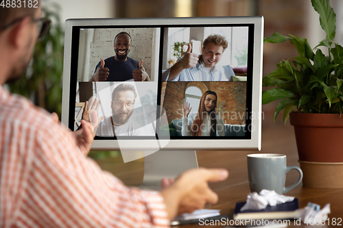 Image of Remote meeting. Man working from home during coronavirus or COVID-19 quarantine, remote office concept.