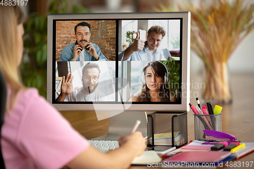 Image of Remote meeting. Woman working from home during coronavirus or COVID-19 quarantine, remote office concept.