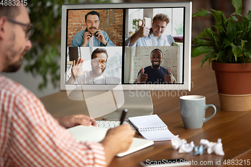 Image of Remote meeting. Man working from home during coronavirus or COVID-19 quarantine, remote office concept.