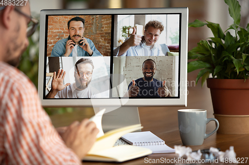 Image of Remote meeting. Man working from home during coronavirus or COVID-19 quarantine, remote office concept.