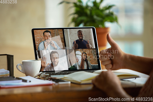 Image of Remote meeting. Man working from home during coronavirus or COVID-19 quarantine, remote office concept.