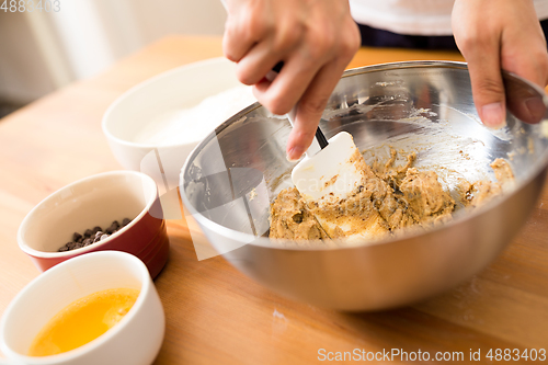 Image of Woman mixing the dough for making cookies