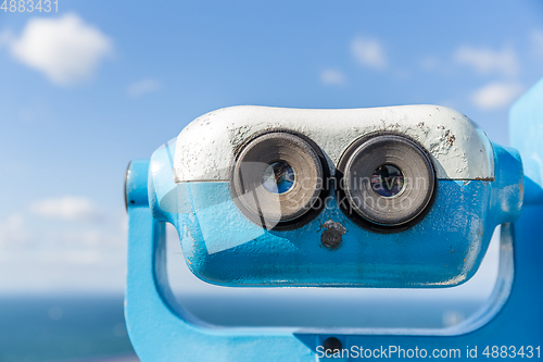 Image of Coin operated binocular viewer with blue sky