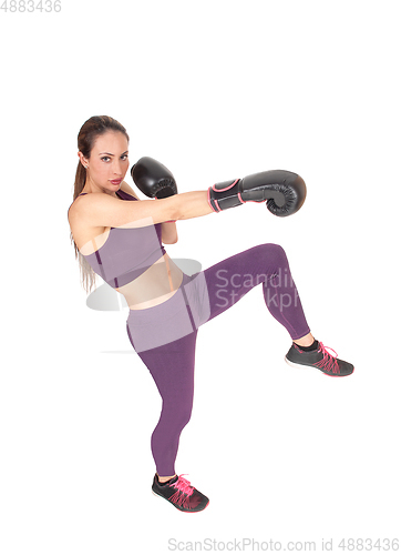 Image of Slim woman in workout outfit boxing