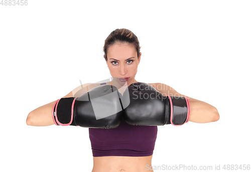 Image of Woman with boxing gloves looking, smiling