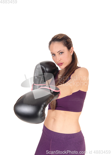 Image of Slim woman punching with boxing cloves