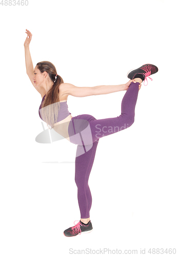 Image of Woman standing and stretching her legs