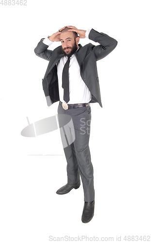 Image of A businessman standing with hands behind head