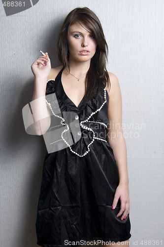 Image of young beautiful girl smoking