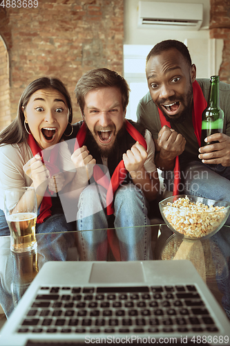 Image of Excited football fans watching sport match at home, remote support of favourite team during coronavirus pandemic outbreak