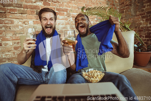 Image of Excited football fans watching sport match at home, remote support of favourite team during coronavirus pandemic outbreak