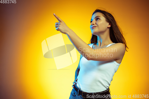 Image of Portrait of young caucasian woman isolated on gradient yellow studio background