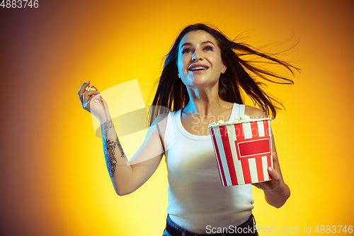 Image of Portrait of young caucasian woman isolated on gradient yellow studio background