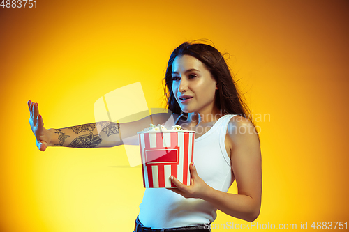 Image of Portrait of young caucasian woman isolated on gradient yellow studio background