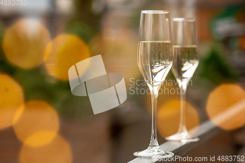 Image of Glasses of sparkling champagne, close up. Warm colored. Celebration event, holidays, drinks concept